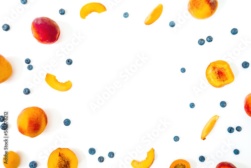 Peaches with blueberries on background. Summer fruits. Top view. Flat lay
