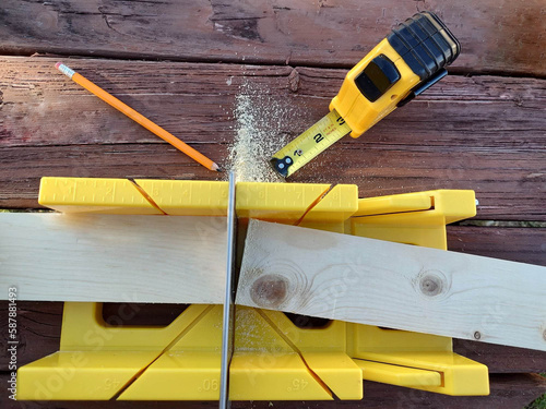 Mitre saw with pencil and tape measure.