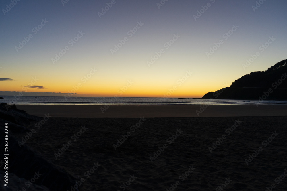 Sandy beach on the Atlantic Ocean, Basque Country sunset time , Spain. sunrise over the bay of biscay beach.