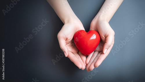 The woman is holding a red heart  world health day concept