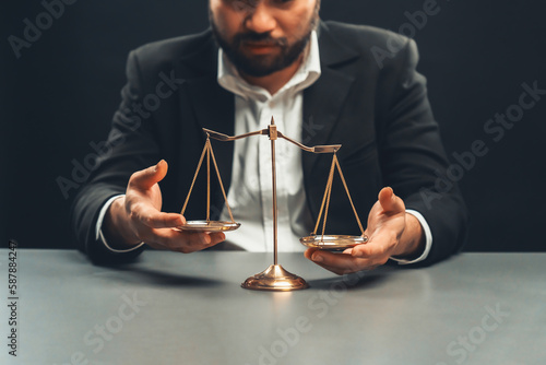 Lawyer or judge in formal black suit hold unbalanced scale with expression of disappointment trying to fix imbalance as anti-injustice concept to fight against corruption of legal system. equility photo