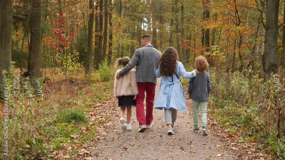 Happy family with children and pet dog walk in a beautiful autumn forest nature together enjoying life Happy family with children and pet dog walk in a beautiful autumn forest nature together enjoying life