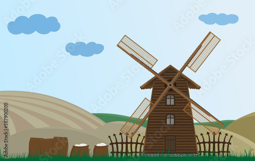 Old wooden windmill in the countryside. Structure for grinding grain. Flour in bags.