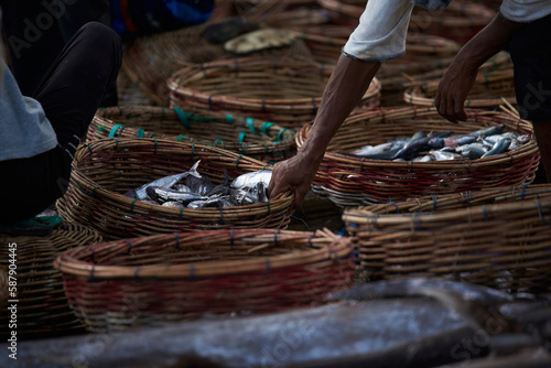 Fresh sardines fish in a wicker basket on the traditional fish market in Indonesia