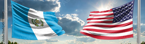 Beautiful national state flags of Guatemala and USA together at the sky background. photo