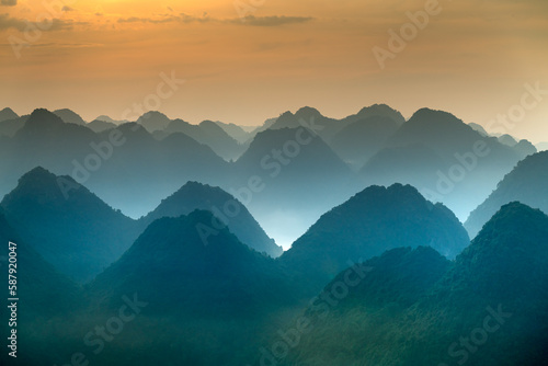 The magical scene of the mountains resemble the successive message they are covered with layers of lush green vegetation at dawn in Bac Son district Lang Son Province, Vietnam
