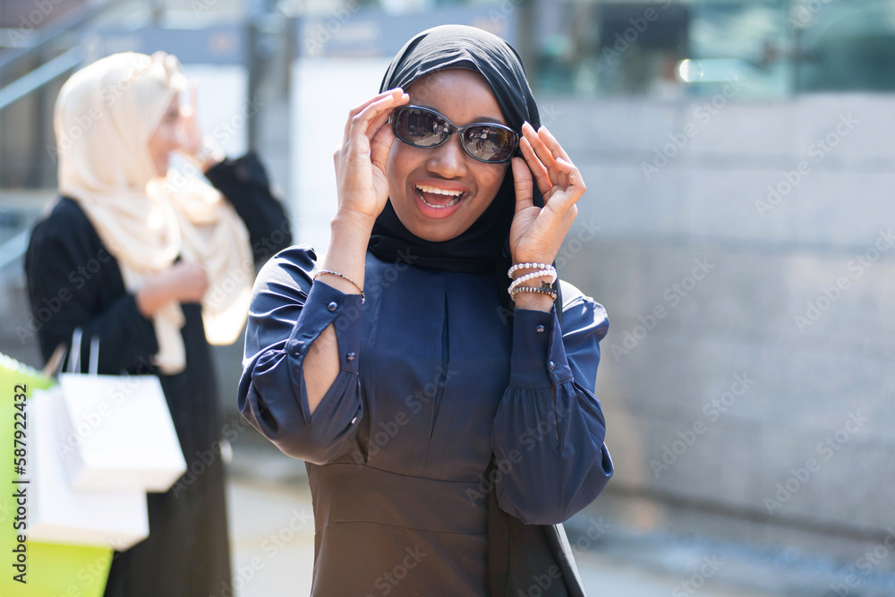 Muslim friends of different nationalities traveling and shopping at Sunday market, Lifestyle of Muslim women in hijab shopping together on weekends Muslim friends of different nationalities traveling and shopping at Sunday market, Lifestyle of Muslim women in hijab shopping together on weekends