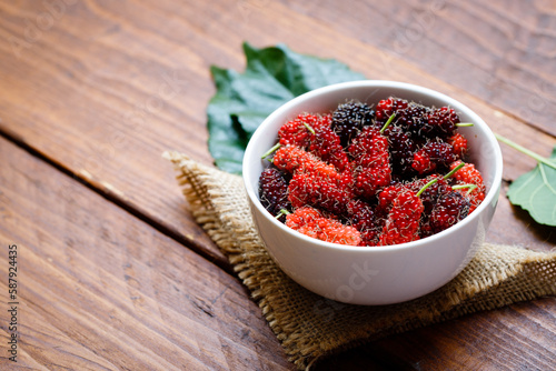 Fresh Organic Mulberries healthy fruit source of vitamin. Red mulberry in white bowl photo