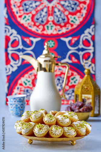 Arabian pancake Qatayef with qishta cream and coffee dallah . Traditional sweets with ramadan decor