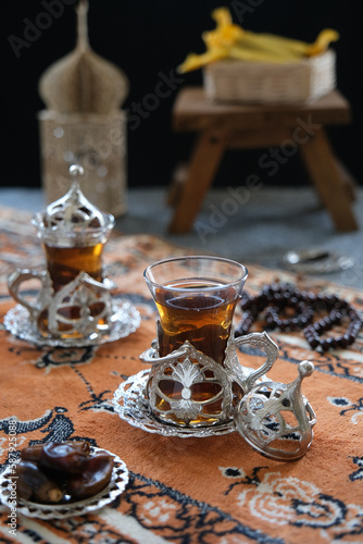 turkish tea on the table  served with date fruits  one sunnah food for breakfasting. ramadhan concept