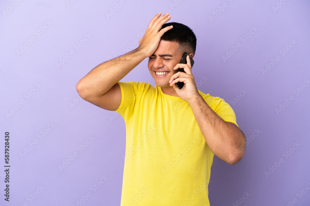 Young handsome man using mobile phone over isolated purple background has realized something and intending the solution Young handsome man using mobile phone over isolated purple background has realized something and intending the solution
