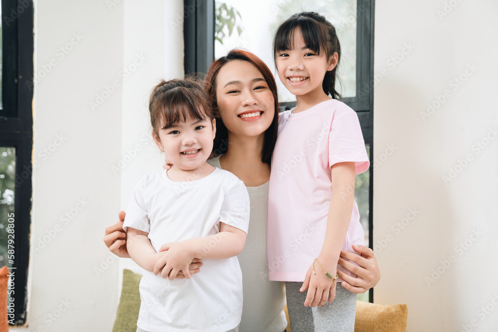 Image of young Asian mother and daughter at home