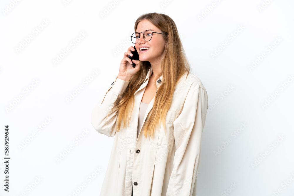 Young blonde woman isolated on white background keeping a conversation with the mobile phone Young blonde woman isolated on white background keeping a conversation with the mobile phone