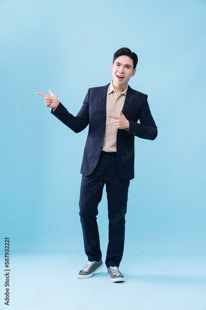 Photo of young Asian businessman on background