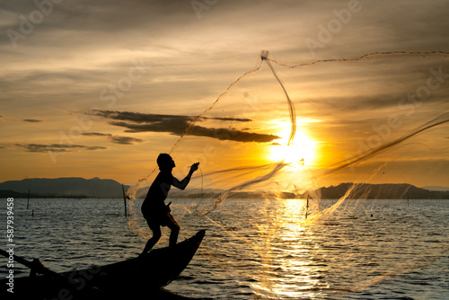 Fishermen are throwing fishing nets into on the river in the sunset in Phu Yen province, Vietnam