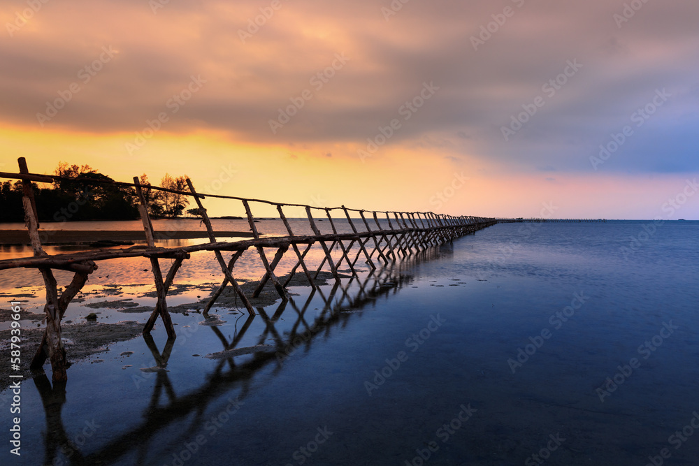Wooden bridge on the beach at dawn in Phu Quoc island, Vietnam. Long exposure time