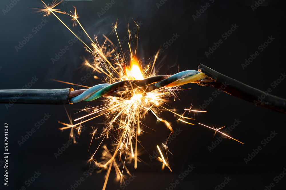 flame smoke and sparks on an electrical cable, fire hazard concept - obrazy, fototapety, plakaty 