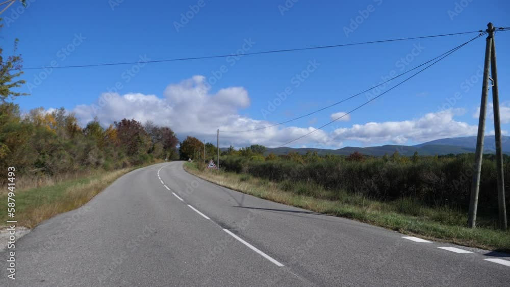 An empty road in the countryside located in the Drome department. Autumn, France. An empty road in the countryside located in the Drome department. Autumn, France.