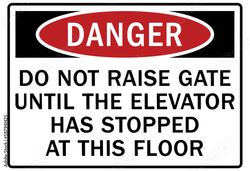 Elevator safety sign and labels do not raise gate until the elevator has stopped at this floor