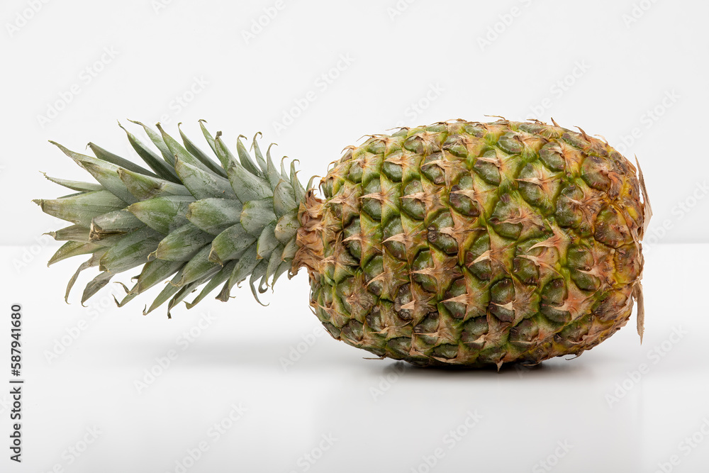 Juicy Pineapple Laid on Its Side with Green Leaves Juicy Pineapple Laid on Its Side with Green Leaves
