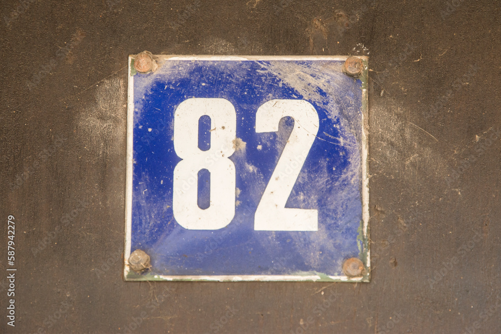 Weathered grunge square metal enameled plate of number of street address with number 82 Weathered grunge square metal enameled plate of number of street address with number 82