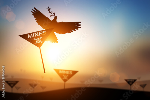 Silhouette of Dove carrying Mines Sign and skull and crossbones symbol for International Day for Mine Awareness and Assistance in Mine Action,4 April  photo
