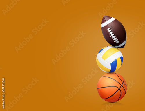 Stack of different sport balls on dark orange background  space for text