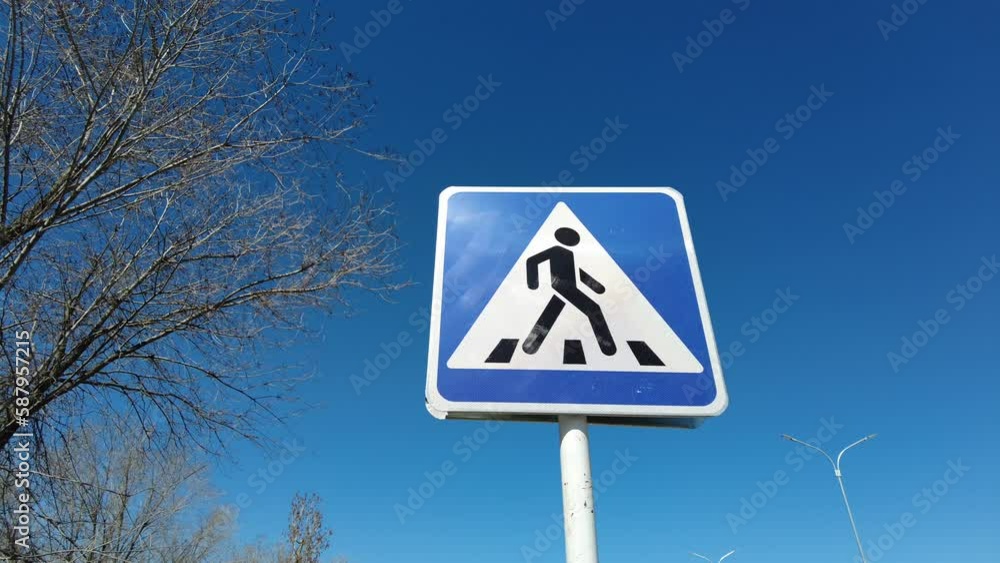 blue pedestrian sign against blue sky blue pedestrian sign against blue sky