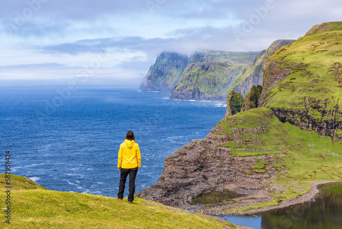 Tourist at Lake Sorvagsvatn or Leitisvatn, Faroe Islands.
