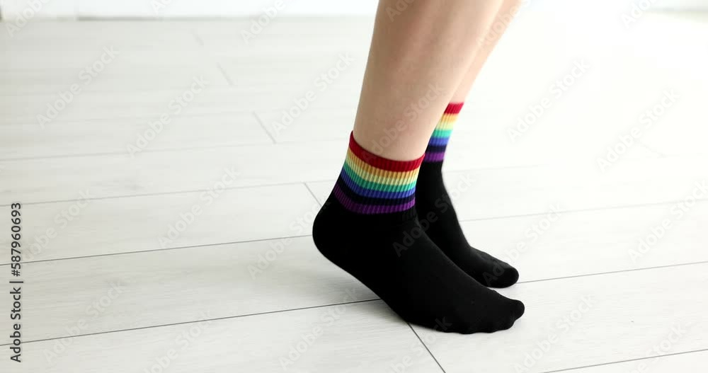 Feet in black socks with lgbt flag jumping on floor closeup 4k movie slow motion. Gender equality concept Feet in black socks with lgbt flag jumping on floor closeup 4k movie slow motion. Gender equality concept