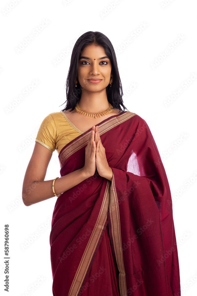 Fototapeta premium Pretty Indian young girl gesturing in traditional saree on white.