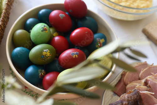 Close-up of Easter breakfast table with traditional slovenian dishes. Ham, colorful eggs, potica and horseraddish.