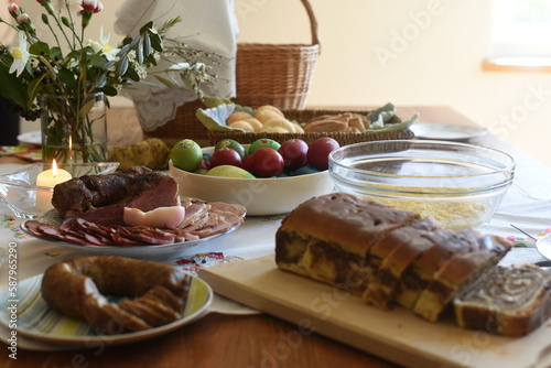 Close-up of Easter breakfast table with traditional slovenian dishes. Ham, colorful eggs, potica and horseraddish.