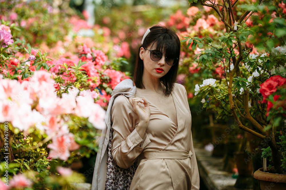 A girl in a flower park on a sunny day A girl in a flower park on a sunny day