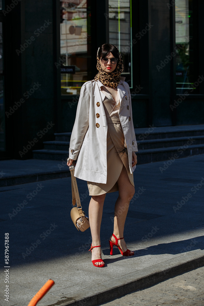 Fototapeta premium A girl in glasses walks around the city