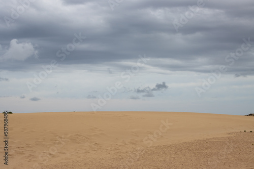 Fototapeta Naklejka Na Ścianę i Meble -  Desert and a cloudy sky, Corralejo, Spain