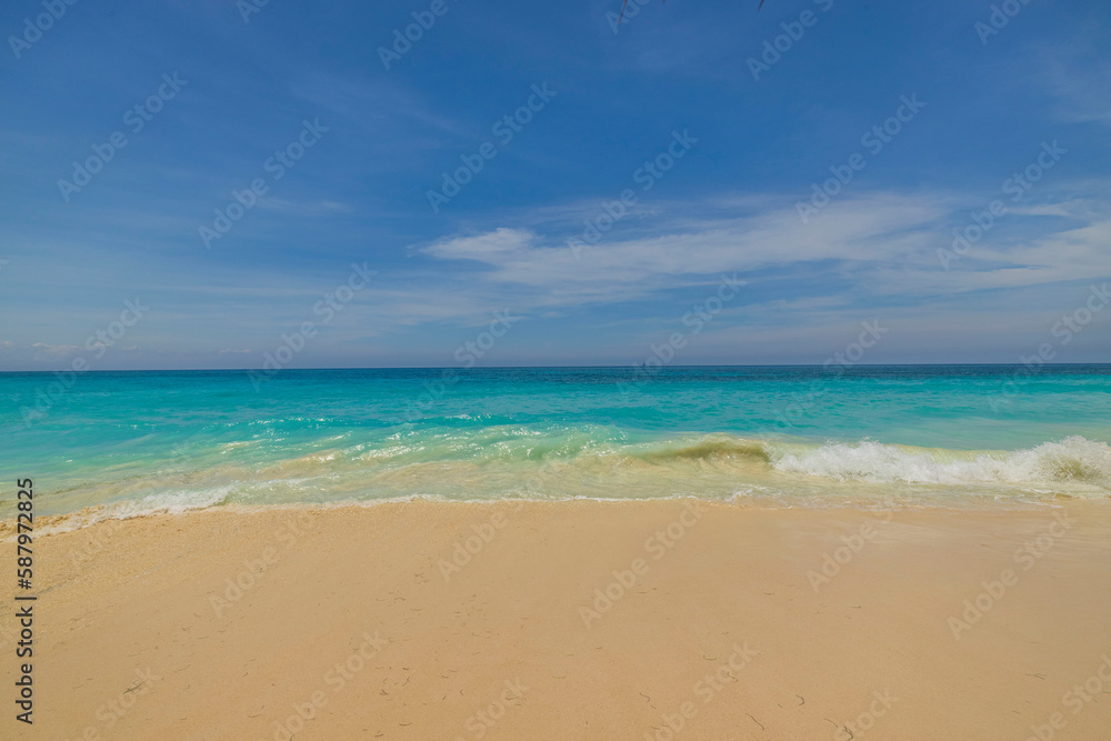 Beautiful nature landscape view of sand beach turquoise water Atlantic ocean surface merging with blue sky. Aruba.  