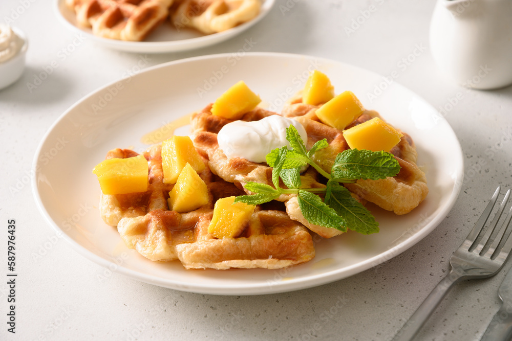 Popular croffles with maple syrup and whipped cream for delicious breakfast. Croissant as waffle. Korean cuisine. Popular croffles with maple syrup and whipped cream for delicious breakfast. Croissant as waffle. Korean cuisine.
