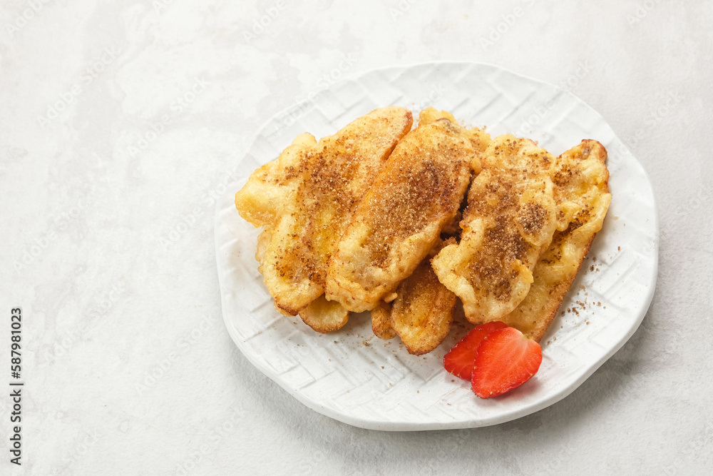 Pisang Goreng or banana fritters with a sprinkling of palm sugar served in white plate. Indonesian food
Pisang Goreng or banana fritters with a sprinkling of palm sugar served in white plate. Indonesian food