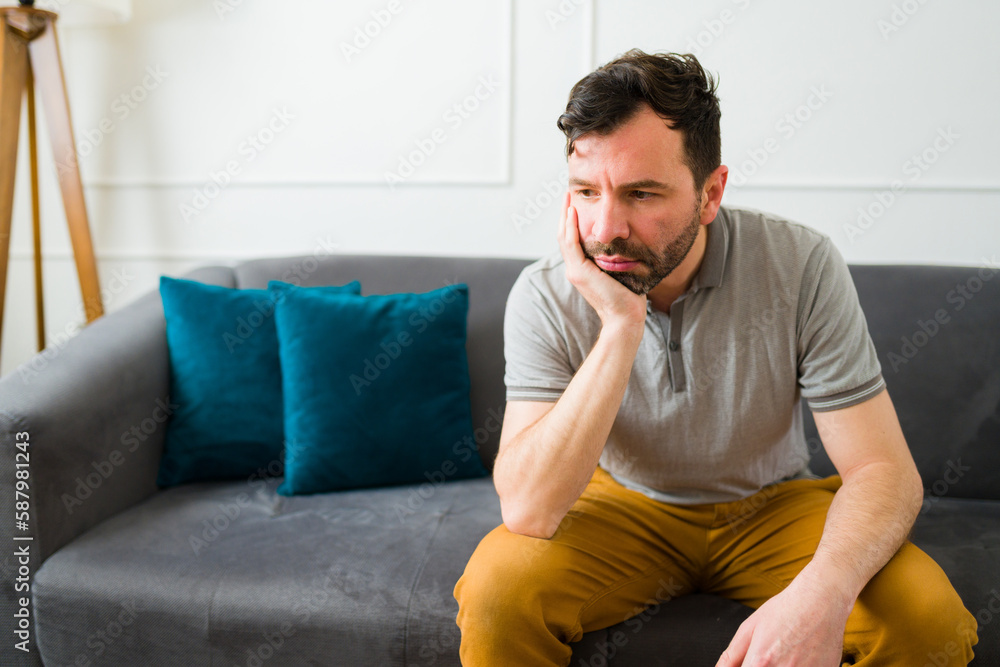 Upset sad man with a lot of problems alone at home