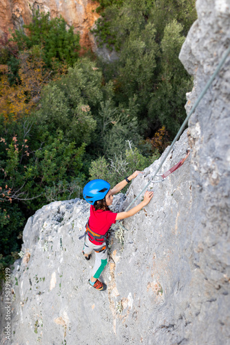 climber boy. the child trains in rock climbing. © zhukovvvlad