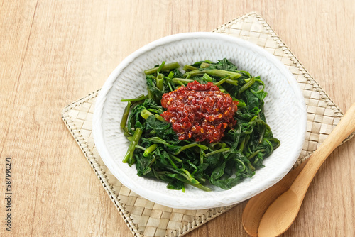 Plecing Kangkung or Brambang Asem, made from boiled spinach served with chili sauce (sambal), spicy and sour. Indonesian food
 photo