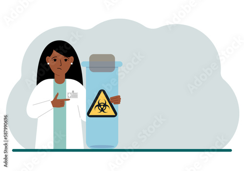 A female doctor or scientist is holding a test tube with a biohazard or virus warning label on it. Biological hazard.