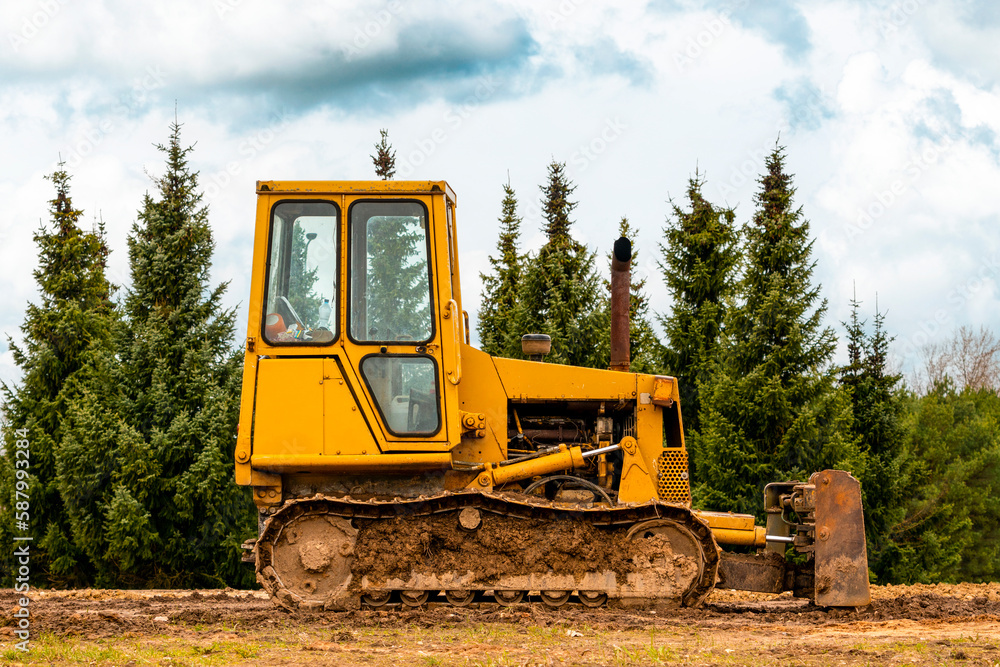 Small crawler bulldozer left on the construction site Small crawler bulldozer left on the construction site