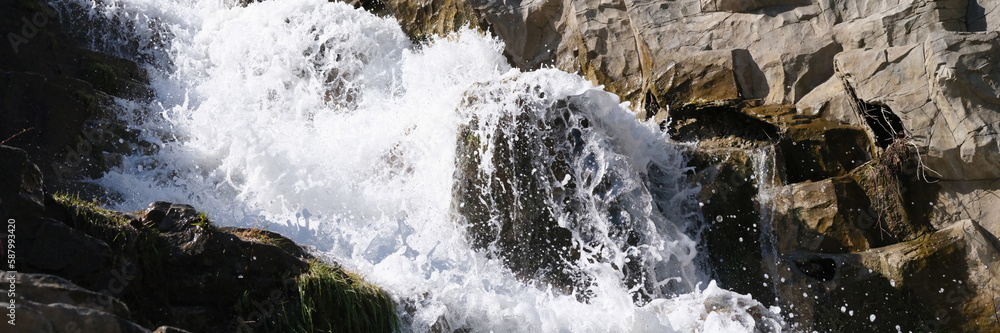 Wild mountain river with small waterfalls flowing through stones Wild mountain river with small waterfalls flowing through stones