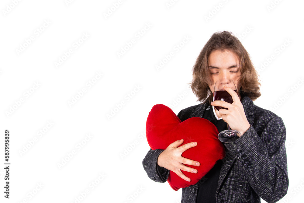 Young attractive guy drinks wine. Gifts and holidays. Young attractive guy drinks wine. Gifts and holidays.