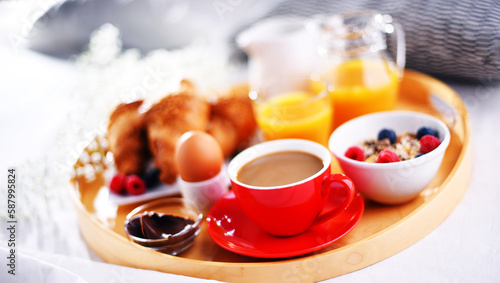 A tray with breakfast on a bed in a hotel room