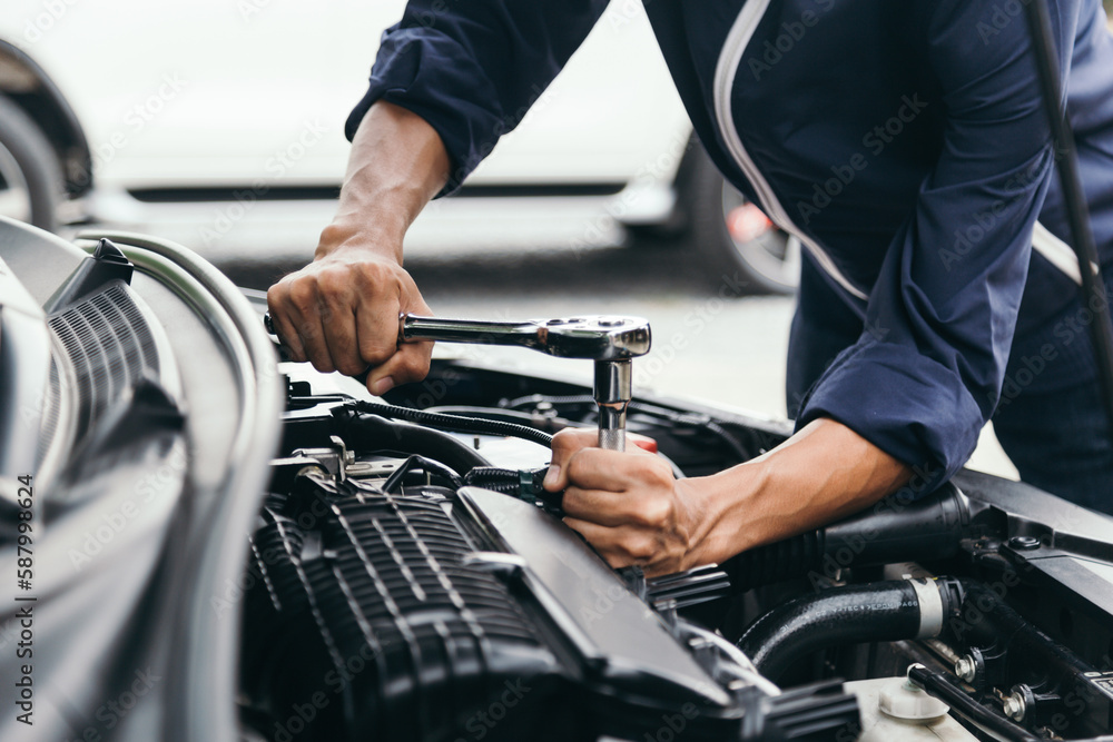Automobile mechanic repairman hands repairing a car engine automotive workshop with a wrench, car service and maintenance,Repair service. Automobile mechanic repairman hands repairing a car engine automotive workshop with a wrench, car service and maintenance,Repair service.