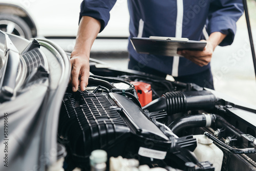 Automobile mechanic repairman hands repairing a car engine automotive workshop with a wrench, car service and maintenance,Repair service.