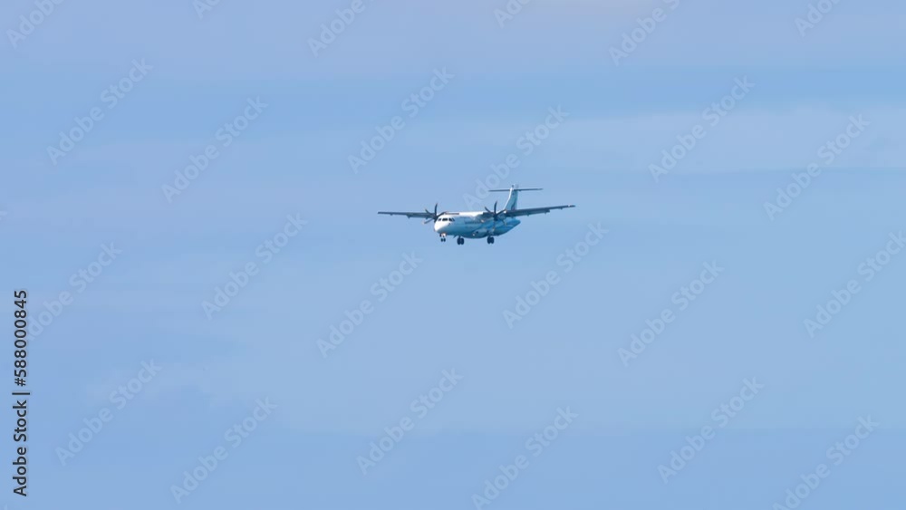 Turboprop passenger plane approaching landing, long shot Turboprop passenger plane approaching landing, long shot